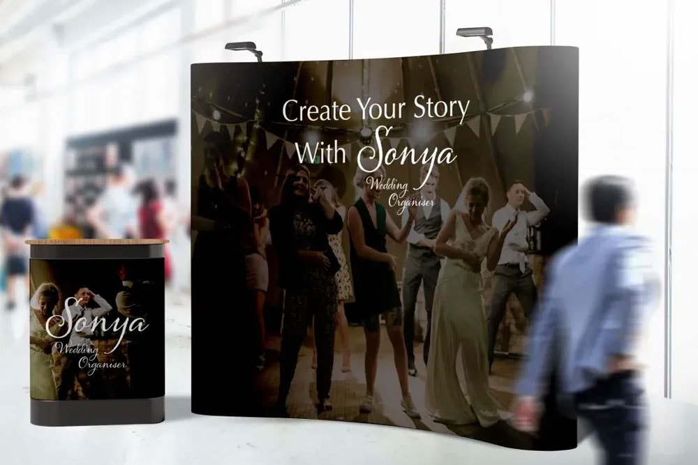 A large pop up stand banner featuring an image of a woman and a man, designed for promotional purposes