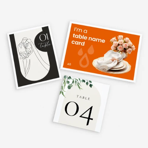 Three wedding table name cards with different designs on a white background.