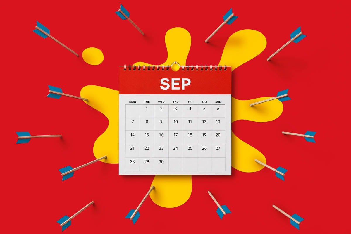 A September calendar with arrows embedded around it on a red and yellow abstract background.