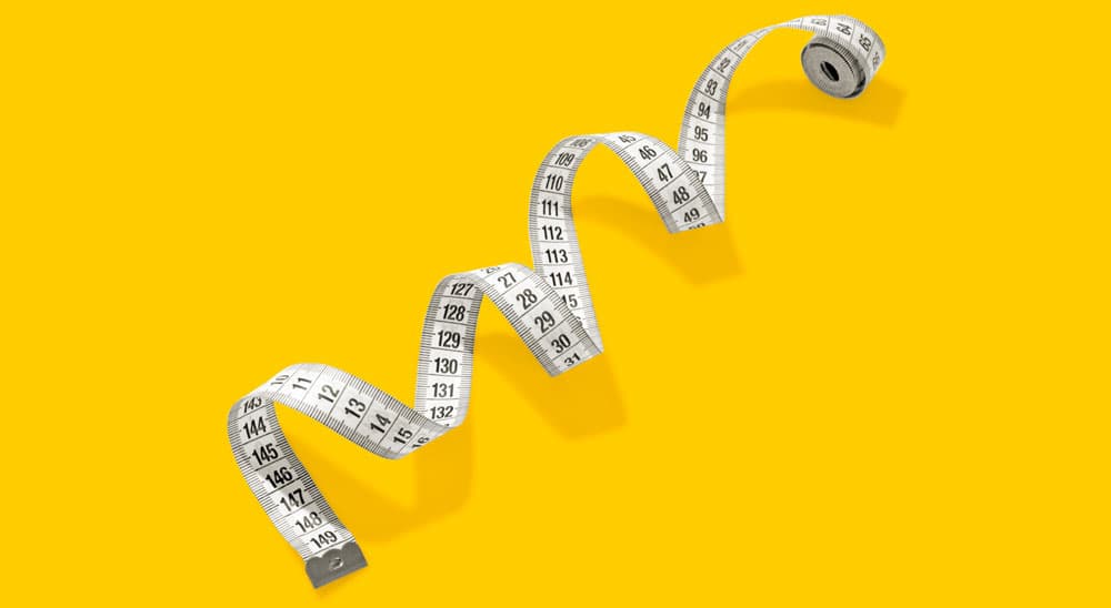 A curled measuring tape is shown against a solid yellow background.