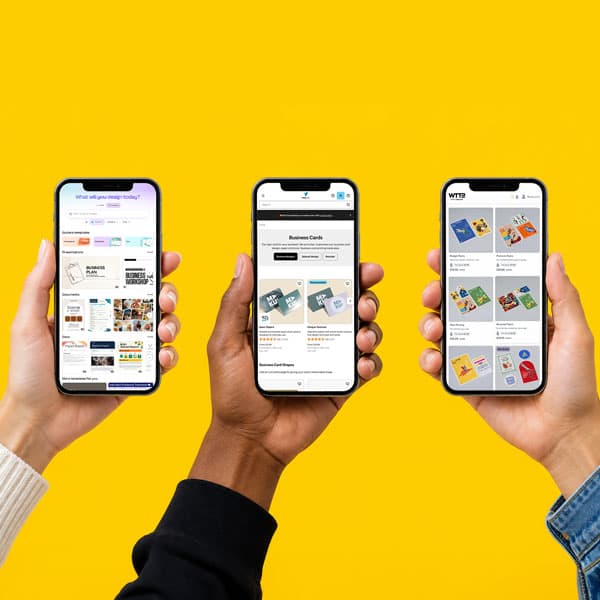 Three hands hold smartphones showing various print and design websites on a yellow background.