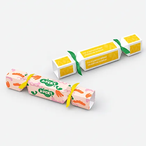 Two colourful Christmas crackers lie side by side on a grey surface.