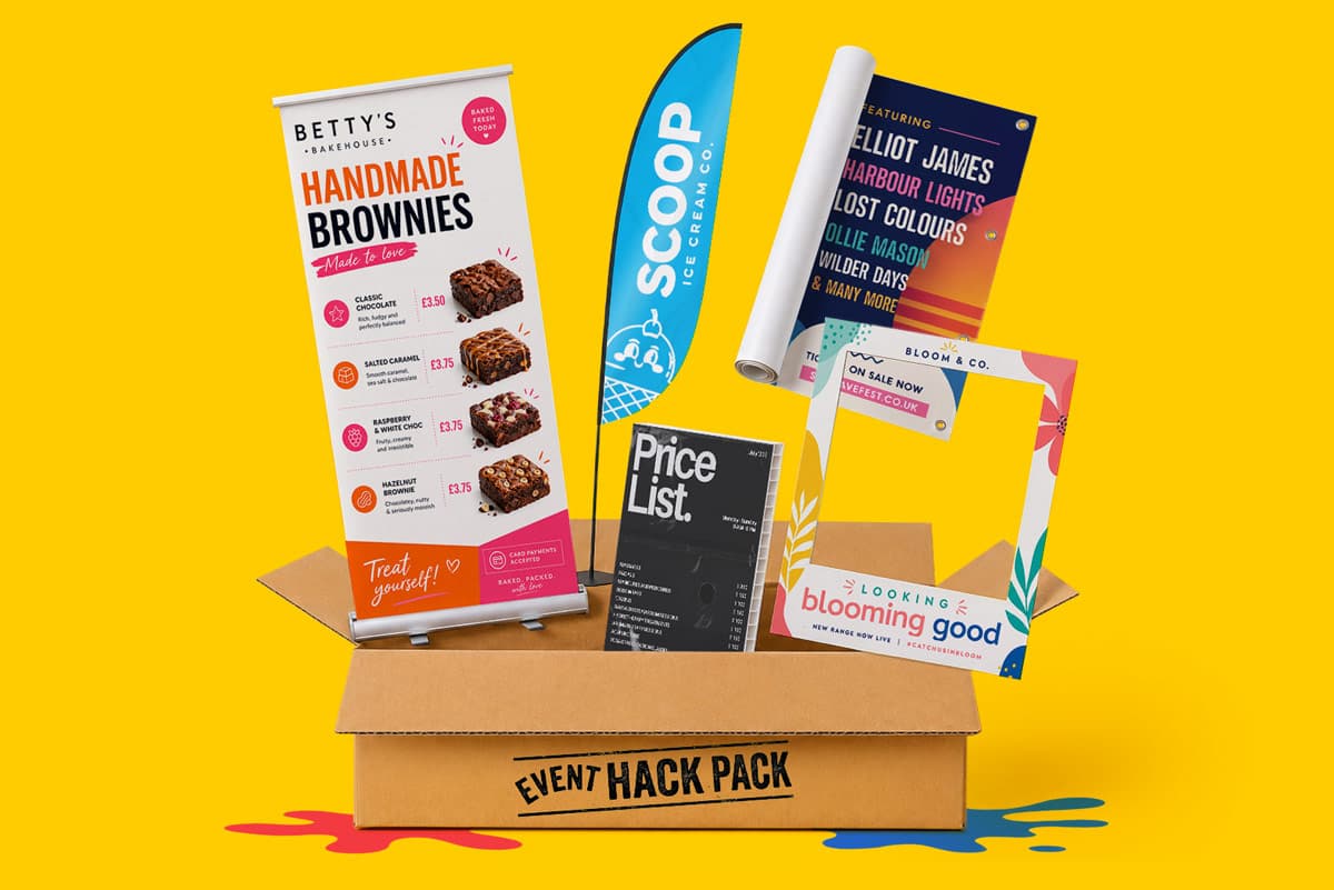 A box labeled "Event Hack Pack" containing various printed event signs, banners, and posters.