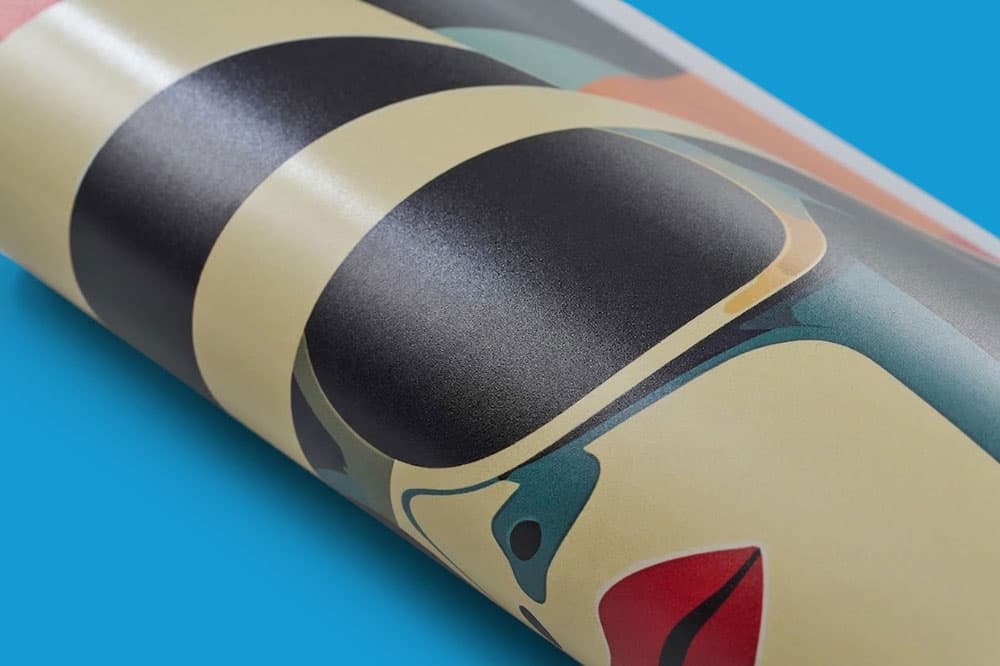 A rolled-up poster with an abstract illustration of a face wearing sunglasses on a blue background.