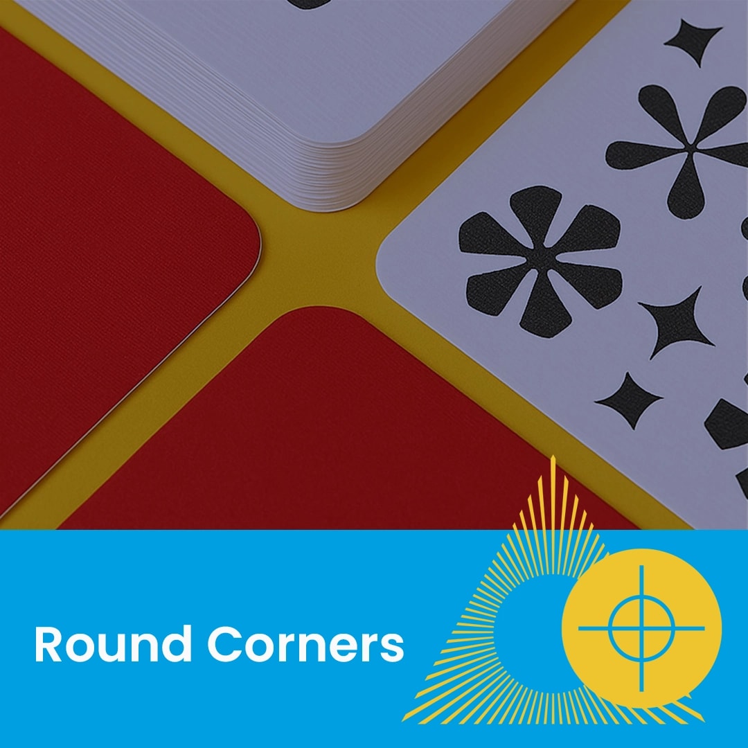 Four playing cards with rounded corners on a yellow surface, two face up and two face down.
