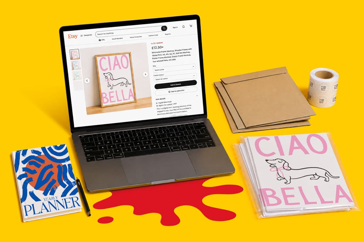 Laptop displaying Etsy page, surrounded by planner, envelopes, stickers, and packaging materials.