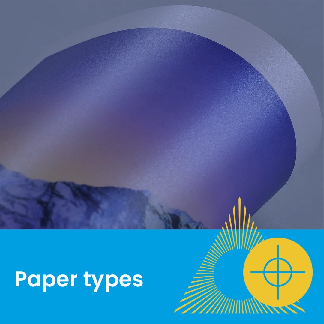 A close-up of a rolled, glossy printed paper with "Paper types" text and graphic overlay.